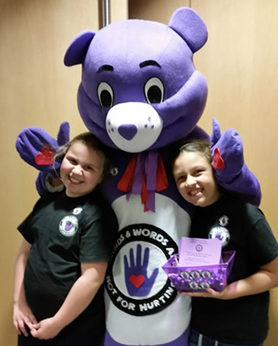 Two young girls with Hands and Words are Not for Hurting purple bear Two young girls with Hands and Words are Not for Hurting purple bear